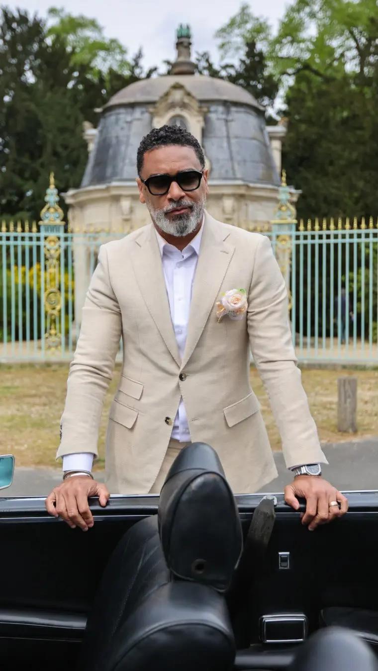 Man in beige suit and white shirt